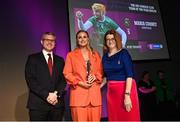25 March 2023; Maria Cooney of Sarsfields, Galway is presented with her 2021/22 Team of the Year award by Uachtarán an Cumann Camógaíochta Hilda Breslin, right, and Chief Marketing Officer of AIB, Mark Doyle during the AIB Camogie Club Player Awards 2023 at Croke Park in Dublin. Photo by David Fitzgerald/Sportsfile