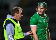 25 March 2023; William O'Donoghue of Limerick leaves the pitch after alongside Limerick team doctor James Ryan, after he was substituted due to injury, during the Allianz Hurling League Division 1 Semi-Final match between Limerick and Tipperary at TUS Gaelic Grounds in Limerick. Photo by Piaras Ó Mídheach/Sportsfile