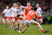 26 March 2023; Cormac Quinn of Tyrone has a shot blocked by Rory Grugan of Armagh during the Allianz Football League Division 1 match between Tyrone and Armagh at O'Neill's Healy Park in Omagh, Tyrone. Photo by Ramsey Cardy/Sportsfile