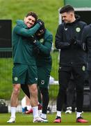 26 March 2023; Robbie Brady, left, is welcomed into the squad by team-mates, including Michael Obafemi and John Egan, right, during a Republic of Ireland training session at the FAI National Training Centre in Abbotstown, Dublin. Photo by Stephen McCarthy/Sportsfile