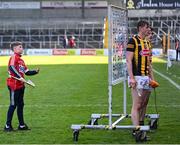 26 March 2023; A young Cork supporter tries to get on TV as Darragh Corcoran and Billy Drennan of Kilkenny are interviewed after the Allianz Hurling League Division 1 Semi Final match between Kilkenny and Cork at UMPC Nowlan Park in Kilkenny. Photo by David Fitzgerald/Sportsfile