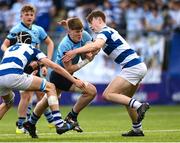 27 March 2023; Myles Berman of St Michael’s College is tackled by Geoffrey Wall, left, and Bernard White of Blackrock College during the Bank of Ireland Leinster Rugby Schools Junior Cup Final match between St Michael's College and Blackrock College at Energia Park in Dublin. Photo by Harry Murphy/Sportsfile