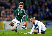 26 March 2023; Conor Bradley of Northern Ireland is tackled by Richard Jensen of Finland during the UEFA EURO 2024 Championship Qualifier match between Northern Ireland and Finland at National Stadium at Windsor Park in Belfast. Photo by Ramsey Cardy/Sportsfile