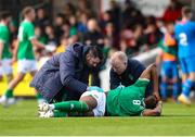 26 March 2023; Bosun Lawal of Republic of Ireland receives medical attention from Republic of Ireland team doctor Dr Mortimer O'Connor, right, and physiotherapist Glauber Barduzzi during the Under-21 international friendly match between Republic of Ireland and Iceland at Turner's Cross in Cork. Photo by Michael P Ryan/Sportsfile