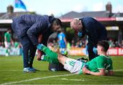 26 March 2023; Andrew Moran of Republic of Ireland receives medical attention from Republic of Ireland team doctor Dr Mortimer O'Connor, right, and physiotherapist Glauber Barduzzi  during the Under-21 international friendly match between Republic of Ireland and Iceland at Turner's Cross in Cork. Photo by Michael P Ryan/Sportsfile
