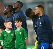 27 March 2023; Mascots turn to look at France captain Kylian Mbappé before the UEFA EURO 2024 Championship Qualifier match between Republic of Ireland and France at Aviva Stadium in Dublin. Photo by Eóin Noonan/Sportsfile