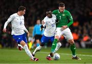27 March 2023; Matt Doherty of Republic of Ireland in action against Randal Kolo Muani, centre, and Benjamin Pavard of France during the UEFA EURO 2024 Championship Qualifier match between Republic of Ireland and France at Aviva Stadium in Dublin. Photo by Stephen McCarthy/Sportsfile