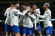27 March 2023; Benjamin Pavard of France, centre, celebrates with team-mates, including from left, Olivier Giroud, Kylian Mbappé and Theo Hernández after scoring their side's first goal during the UEFA EURO 2024 Championship Qualifier match between Republic of Ireland and France at Aviva Stadium in Dublin. Photo by Eóin Noonan/Sportsfile
