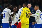 27 March 2023; France goalkeeper Mike Maignan celebrates with Kylian Mbappé, right, and Dayot Upamecano after the UEFA EURO 2024 Championship Qualifier match between Republic of Ireland and France at Aviva Stadium in Dublin. Photo by Seb Daly/Sportsfile