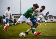 28 March 2023; Kevin Zefi of Republic of Ireland in action against Zisis Tsikos of Greece during the UEFA European Under-19 Championship Elite Round match between Greece and Republic of Ireland at Ferrycarrig Park in Wexford. Photo by Stephen McCarthy/Sportsfile