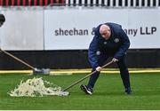 31 March 2023; St Patrick's Athletic groundstaff clear the water from the pitch during the pitch inspection before the SSE Airtricity Men's Premier Division match between St Patrick's Athletic and UCD at Richmond Park in Dublin. Photo by Ben McShane/Sportsfile