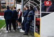 31 March 2023; St Patrick's Athletic players, including Serge Atakayi, centre, await the decision of the pitch inspection before the SSE Airtricity Men's Premier Division match between St Patrick's Athletic and UCD at Richmond Park in Dublin. Photo by Ben McShane/Sportsfile