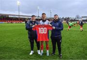 31 March 2023; Luke Byrne of Shelbourne is presented with a shirt to mark his 100th appearance for the club by Shelbourne equipment manager Graham Watson, left, and Karl Watson before the SSE Airtricity Premier Division match between Shelbourne and Derry City at Tolka Park in Dublin. Photo by Seb Daly/Sportsfile