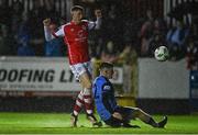 31 March 2023; Chris Forrester of St Patrick's Athletic scores his side's third goal despite the attempted tackle of Michael Gallagher of UCD during the SSE Airtricity Men's Premier Division match between St Patrick's Athletic and UCD at Richmond Park in Dublin. Photo by Ben McShane/Sportsfile