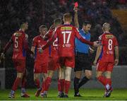31 March 2023; Referee Paul McLaughlin shows a red card to Paddy Barrett of Shelbourne, third from left, during the SSE Airtricity Men's Premier Division match between Shelbourne and Derry City at Tolka Park in Dublin. Photo by Seb Daly/Sportsfile