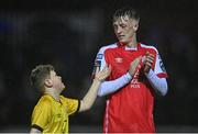 31 March 2023; Chris Forrester of St Patrick's Athletic with a young supporter after the SSE Airtricity Men's Premier Division match between St Patrick's Athletic and UCD at Richmond Park in Dublin. Photo by Ben McShane/Sportsfile