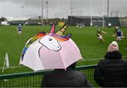 1 April 2023; Leitrim supporter Aine Byrne from Eslin, Leitrim watches on from underneath an umbrella during the Allianz Hurling League Division 3B Final match between Cavan and Leitrim at GAA National Games Development Centre in Sport Ireland Campus in Dublin. Photo by David Fitzgerald/Sportsfile