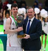 1 April 2023; Emporium Cork Basketball captain Adrian O'Sullivan is presented the cup by Basketball Ireland CEO John Feehan after the InsureMyVan.ie Super League final match between Emporium Cork Basketball and University of Galway Maree at National Basketball Arena in Tallaght, Dublin. Photo by Ben McShane/Sportsfile