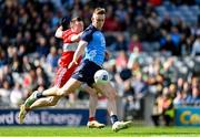 2 April 2023; Tom Lahiff of Dublin shoots at goal under pressure from Gareth McKinless of Derry during the Allianz Football League Division 2 Final match between Dublin and Derry at Croke Park in Dublin. Photo by Ramsey Cardy/Sportsfile