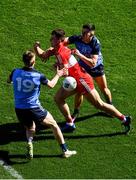 2 April 2023; Shane McGuigan of Derry is tackled by Tom Lahiff, 19, and Cian Murphy of Dublin during the Allianz Football League Division 2 Final match between Dublin and Derry at Croke Park in Dublin. Photo by Tyler Miller/Sportsfile