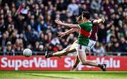 2 April 2023; Damien Comer of Galway has  a shot on goal despite the efforts of Diarmuid O'Connor of Mayo during the Allianz Football League Division 1 Final match between Galway and Mayo at Croke Park in Dublin. Photo by Sam Barnes/Sportsfile