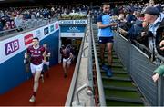2 April 2023; James McCarthy of Dublin walks down the Hogan Stand steps after winning the Allianz Football League Division 2 Final against Derry, as Damien Comer of Galway runs out of the tunnel before the Allianz Football League Division 1 Final match against Mayo at Croke Park in Dublin. Photo by Ramsey Cardy/Sportsfile