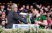 2 April 2023; Uachtarán Chumann Lúthchleas Gael Larry McCarthy presents to the cup to Paddy Durcan of Mayo during the Allianz Football League Division 1 Final match between Galway and Mayo at Croke Park in Dublin. Photo by Sam Barnes/Sportsfile