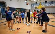 6 April 2023; Ciara Butler, left, and Aishling O'Connell of Kerry with fifth grade students during a Ladies Football coaching clinic at the Casis Elementary School during the 2023 TG4 LGFA All-Star Tour to Austin in Texas, USA. Photo by Brendan Moran/Sportsfile