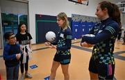 6 April 2023; Mary-Kate Lynch of Meath, left, and Kayleigh Cronin of Kerry with fourth grade students during a Ladies Football coaching clinic at the Casis Elementary School during the 2023 TG4 LGFA All-Star Tour to Austin in Texas, USA. Photo by Brendan Moran/Sportsfile