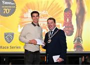 6 April 2023; Eoin Everard of Kilkenny City Harriers, left, who finished fourth, receives his prize from Cathaoirleach Pat Fitzpatrick after the Peugeot Race Series - Streets of Kilkenny 2023 in Kilkenny. Photo by Sam Barnes/Sportsfile