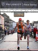 6 April 2023; Athletes Daniel Ryan Ellis of Nenagh Olympic AC, Tipperary, and Sean Quinn of Dundrum South Dublin AC,  cross the finish line during the Peugeot Race Series - Streets of Kilkenny 2023 in Kilkenny. Photo by Sam Barnes/Sportsfile