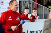 7 April 2023; Young St Patrick's Athletic supporters enjoy their chips as Cork City manager Colin Healy awaits to be interviewed before the SSE Airtricity Men's Premier Division match between St Patrick's Athletic and Cork City at Richmond Park in Dublin. Photo by Michael P Ryan/Sportsfile