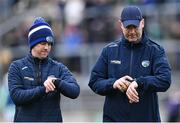 8 April 2023; Laois manager Willie Maher, right, and his selector Eamon Jackson check their watches before the Joe McDonagh Cup Round 1 match between Offaly and Laois at Glenisk O'Connor Park in Tullamore, Offaly. Photo by Piaras Ó Mídheach/Sportsfile