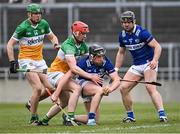 8 April 2023; Donnchadh Hartnett of Laois, supported by teammate Liam O'Connell, 7, in action against Offaly players Brian Duignan, 14, and Charlie Mitchell of Offaly during the Joe McDonagh Cup Round 1 match between Offaly and Laois at Glenisk O'Connor Park in Tullamore, Offaly. Photo by Piaras Ó Mídheach/Sportsfile