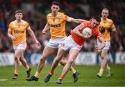 8 April 2023; Shane McPartlan of Armagh in action against Conor Stewart of Antrim during the Ulster GAA Football Senior Championship preliminary round match between Armagh and Antrim at Box-It Athletic Grounds in Armagh. Photo by Ramsey Cardy/Sportsfile