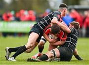 9 April 2023; Calum O'Brien of Cill Dara is tackled by Jake McDonald, left, and Garry Dunne of Kilkenny during the Bank of Ireland Provincial Towns Cup Semi-Final match between Kilkenny RFC and Cill Dara RFC at Portlaoise RFC in Portlaoise, Laois. Photo by Ben McShane/Sportsfile