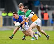 9 April 2023; Daniel Mimnagh of Longford is tackled by Offaly players Rory Egan and Dylan Hyland, 13, during the Leinster GAA Football Senior Championship Round 1 match between Longford and Offaly at Glennon Brothers Pearse Park in Longford. Photo by Ray McManus/Sportsfile