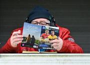 9 April 2023; Liam Mac an Mhaoir of Raidió na Gaeltachta reads his the programme before the Munster GAA Football Senior Championship Quarter-Final match between Clare and Cork at Cusack Park in Ennis, Clare. Photo by Piaras Ó Mídheach/Sportsfile