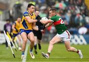 9 April 2023; Conor Hussey of Roscommon in action against Eoghan McLaughlin of Mayo during the Connacht GAA Football Senior Championship Quarter-Final match between Mayo and Roscommon at Hastings Insurance MacHale Park in Castlebar, Mayo. Photo by Ramsey Cardy/Sportsfile