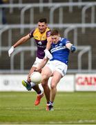 9 April 2023; Evan O'Carroll of Laois in action against Brian Molloy of Wexford during the Leinster GAA Football Senior Championship Round 1 match between Laois and Wexford at Laois Hire O'Moore Park in Portlaoise, Laois. Photo by Tom Beary/Sportsfile
