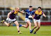 9 April 2023; Patrick O'Sullivan of Laois in action against Kevin O'Grady, left, and Brian Molloy of Wexford during the Leinster GAA Football Senior Championship Round 1 match between Laois and Wexford at Laois Hire O'Moore Park in Portlaoise, Laois. Photo by Tom Beary/Sportsfile
