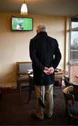 9 April 2023; Racegoer Sean Harvey watches the Connacht GAA Football Senior Championship Quarter-Final match between Mayo and Roscommon, in the press room on day two of the Fairyhouse Easter Festival at Fairyhouse Racecourse in Ratoath, Meath. Photo by Harry Murphy/Sportsfile
