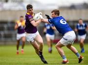 9 April 2023; Niall Hughes of Wexford in action against Mark Timmons of Laois during the Leinster GAA Football Senior Championship Round 1 match between Laois and Wexford at Laois Hire O'Moore Park in Portlaoise, Laois. Photo by Tom Beary/Sportsfile