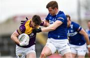 9 April 2023; Niall Hughes of Wexford in action against Mark Timmons of Laois during the Leinster GAA Football Senior Championship Round 1 match between Laois and Wexford at Laois Hire O'Moore Park in Portlaoise, Laois. Photo by Tom Beary/Sportsfile
