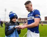 9 April 2023; Patrick O'Sullivan of Laois signs an autograph for AJ Brophy, age 10, following the Leinster GAA Football Senior Championship Round 1 match between Laois and Wexford at Laois Hire O'Moore Park in Portlaoise, Laois. Photo by Tom Beary/Sportsfile