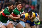 9 April 2023; Conor Daly of Roscommon is tackled by Aidan O'Shea, left, and Fionn McDonagh of Mayo during the Connacht GAA Football Senior Championship Quarter-Final match between Mayo and Roscommon at Hastings Insurance MacHale Park in Castlebar, Mayo. Photo by Ramsey Cardy/Sportsfile