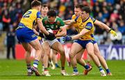 9 April 2023; Tommy Conroy of Mayo under pressure from Roscommon players, from left, Enda Smith, Niall Daly and Conor Hussey during the Connacht GAA Football Senior Championship Quarter-Final match between Mayo and Roscommon at Hastings Insurance MacHale Park in Castlebar, Mayo. Photo by Ramsey Cardy/Sportsfile