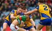 9 April 2023; Tommy Conroy of Mayo under pressure from Roscommon players, from left, Niall Daly, Conor Daly and Conor Hussey during the Connacht GAA Football Senior Championship Quarter-Final match between Mayo and Roscommon at Hastings Insurance MacHale Park in Castlebar, Mayo. Photo by Ramsey Cardy/Sportsfile