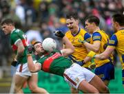 9 April 2023; Aidan O'Shea of Mayo in falls back against Conor Hussey and David Murray of Roscommon during the Connacht GAA Football Senior Championship Quarter-Final match between Mayo and Roscommon at Hastings Insurance MacHale Park in Castlebar, Mayo. Photo by Ray Ryan/Sportsfile
