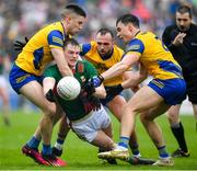 9 April 2023; Matthew Ruane of Mayo in action against, from left, Conor Daly, Donie Smith and Conor Hussey of Roscommon during the Connacht GAA Football Senior Championship Quarter-Final match between Mayo and Roscommon at Hastings Insurance MacHale Park in Castlebar, Mayo. Photo by Ray Ryan/Sportsfile